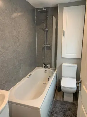 a bathroom with a tub and a toilet and a sink at 6 Tai Isa, A Hidden Gem in Barmouth