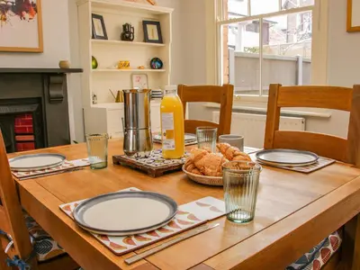 a wooden table with plates and food on it at Willow View in Shrewsbury
