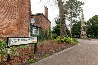 a sign in front of a brick building at Coach House, Shrewsbury Town in Shrewsbury