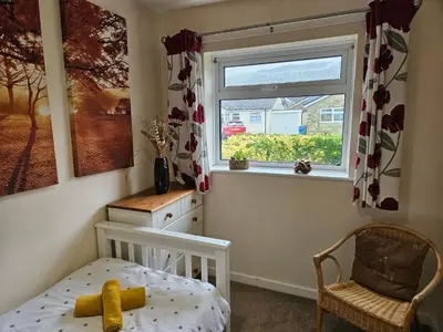 a bedroom with a bed and a window at Ridge And Tides in Fairbourne