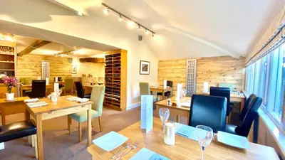 a dining room with a table and chairs at Castle Cottage Inn in Harlech