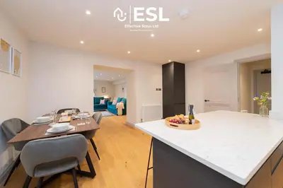 a kitchen and living room with a table and chairs at High Quality 2 Bedroom Church Apartment 5 Mins to Town Centre - Free Parking in Shrewsbury