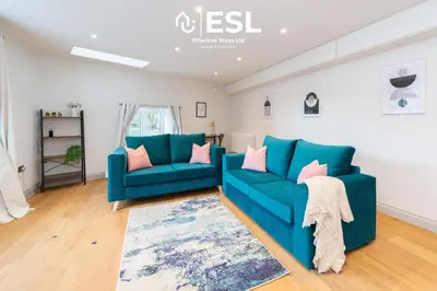 a living room with a blue couch and a rug at High Quality 2 Bedroom Church Apartment 5 Mins to Town Centre - Free Parking in Shrewsbury