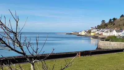 a view of a body of water with houses at Tŷ Treflan in Aberdyfi