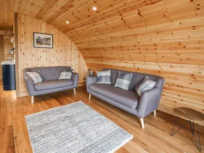 a living room with two couches in a log cabin at Bluebell in Rhayader