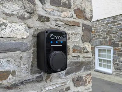 a black object is attached to a stone wall at Llys Bach Apartment at Llys Aeron in Aberaeron