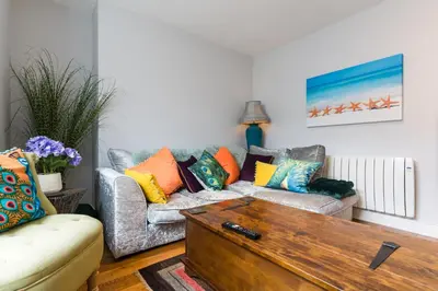 a living room with a couch and a coffee table at No 31 Promenade APARTMENT by the sea in Aberystwyth