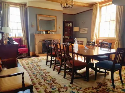 a dining room with a table and chairs at Upper Buckton B&B in Leintwardine