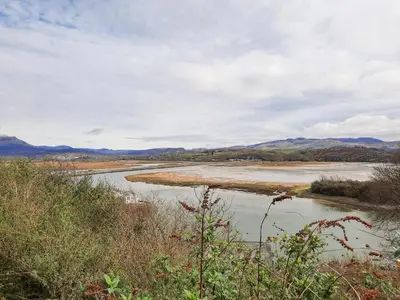 a view of a river with mountains in the background at Emerald Suite in Barmouth