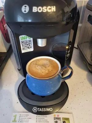 a coffee maker with a blue cup of coffee at Forester's Retreat Glamping - Cambrian View- Vaccinated dogs over the age of 2 are accepted in Aberystwyth