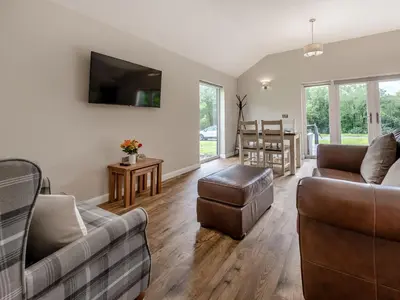 a living room with two couches and a table at Dwrgi - Uk32923 in Cwrt-newydd