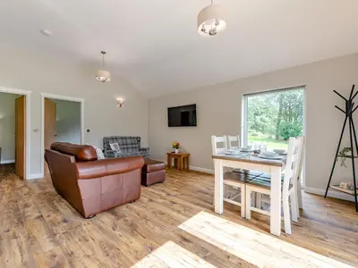 a living room with a couch and a table at Dwrgi - Uk32923 in Cwrt-newydd
