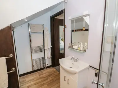a bathroom with a sink and a mirror at The Wheelhouse at Dudgeley Mill in Church Stretton