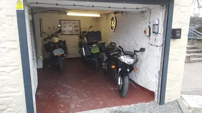 two motorcycles are parked in a garage at Riverbank Bed and Breakfast in Llanwrtyd Wells