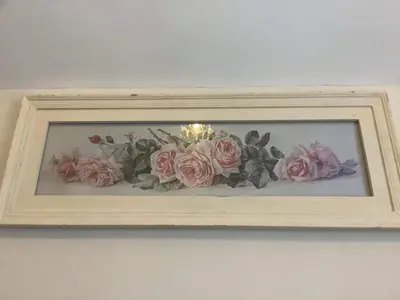 a picture of flowers in a frame on a wall at Lavender Cottage in Presteigne