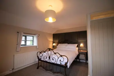 a bedroom with a large bed and a window at The Old Cider House in Hay-on-Wye