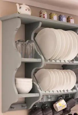 a shelf in a kitchen with plates and bowls at The Old Cider House in Hay-on-Wye