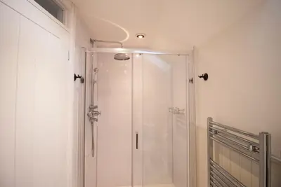 a shower with a glass door in a bathroom at The Old Cider House in Hay-on-Wye