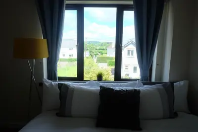 a bedroom with a bed with a large window at 15 Bronant in Talgarth