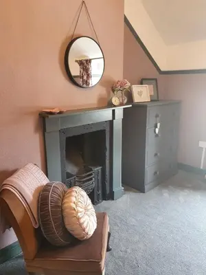 a living room with a fireplace and a mirror at Llangollen 1-Bed Cottage Sleeps 2 with Parking in Llangollen