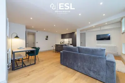 a living room with a couch and a table at Modern 2 Bedroom Church Apartment 5 Mins to Town Centre - Free Parking in Shrewsbury
