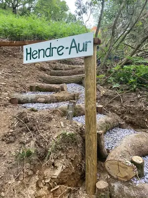 a sign that says harride art next to a creek at Hillside hideaway - Hendre-Aur Pod in Machynlleth