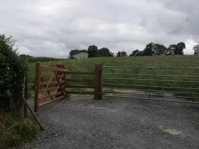 a gate in a field with a fence at Y Cwtch in Trefeglwys