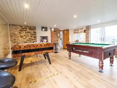 a room with two pool tables and a stone wall at Bwthyn Y Bugail Shepherd's Cottage in Oswestry