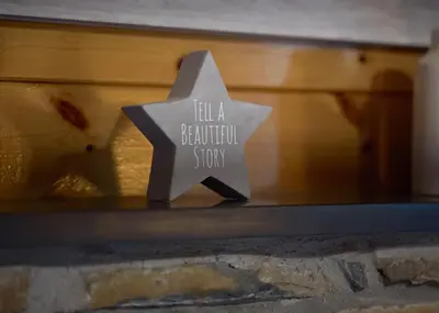 a paper star with the words tell a beautiful story at Luxury Wood Lodge with sauna, log burner & private woodland garden - Wnion Wood Lodge in Llanfachreth