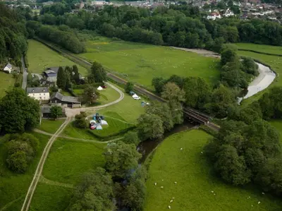 an aerial view of a park with a river at Panpwnton Farm Bell Tents in Knighton