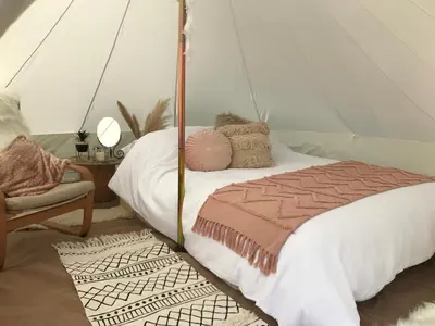 a bedroom with a bed in a tent at Panpwnton Farm Bell Tents in Knighton