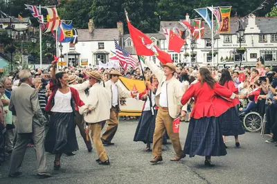 a group of people walking in a parade with flags at Fern Studio 1 Bedroom Apartment in Llangollen