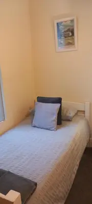 a bedroom with a bed with a blue pillow on it at 2 Bodwen Villas in Llangollen
