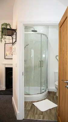 a glass shower in a bathroom with a toilet at The Yew Tree Inn in Church Stretton