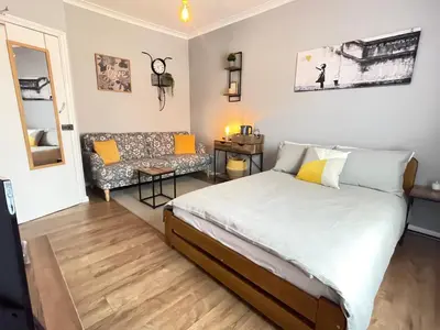 a bedroom with a bed and a couch at Westend Holiday Room 4 Brecon in Brecon