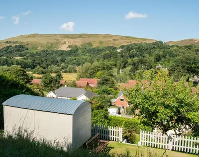 an overhead view of a farm with a fence and a building at Hilltop Hut in Church Stretton