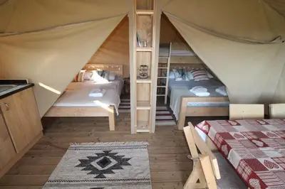 a room with two beds in a tent at Safari Tent with Hot Tub in heart of Snowdonia in Dolgellau