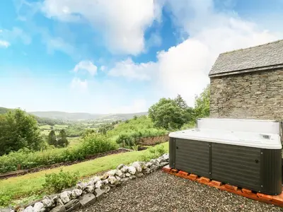 a bath tub sitting on the side of a stone building at Pant Y Rhedyn in Llandrindod Wells