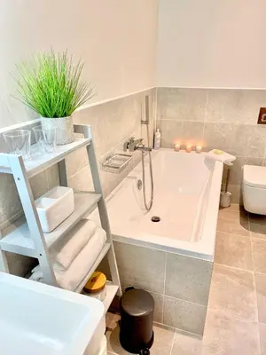 a bathroom with a tub and a toilet and a sink at Apartment Twelve in Shrewsbury