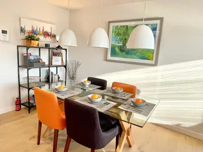 a dining room with a glass table and chairs at Apartment Twelve in Shrewsbury