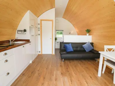 a living room with a couch and a table at Seren in Llandrindod Wells