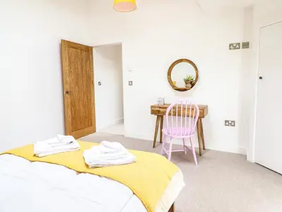 a bedroom with a bed and a table with a chair at Swallows Rest in Montgomery
