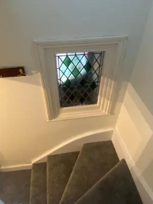 a staircase with a window in a stair case at Ravelstone in Church Stretton