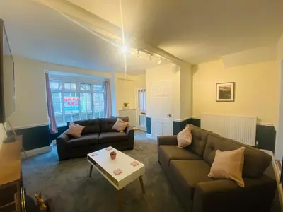 a living room with two couches and a coffee table at Ravelstone in Church Stretton