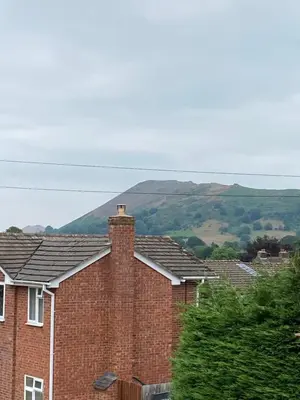 a row of brick houses with hills in the background at Ravelstone in Church Stretton