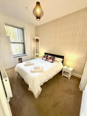 a bedroom with a large white bed in a room at Bellaview Apartment Barmouth in Barmouth