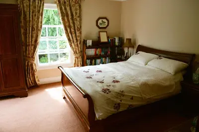 a bedroom with a bed and a window at The Old Vicarage in Shrewsbury