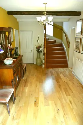 a living room with a staircase and wooden floors at The Old Vicarage in Shrewsbury