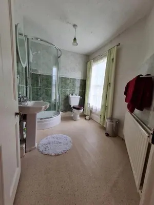 a bathroom with a sink and a toilet and a shower at The Old Vicarage in Shrewsbury