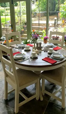 a table with chairs and plates and napkins on it at The Old Vicarage in Shrewsbury